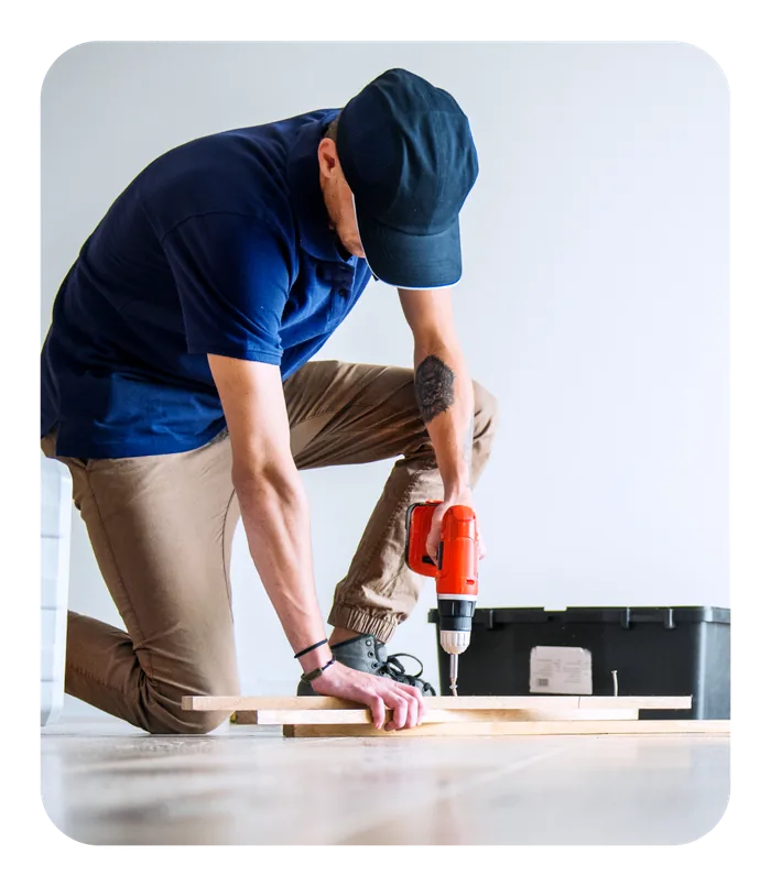 Contractor installing flooring during an office renovation
